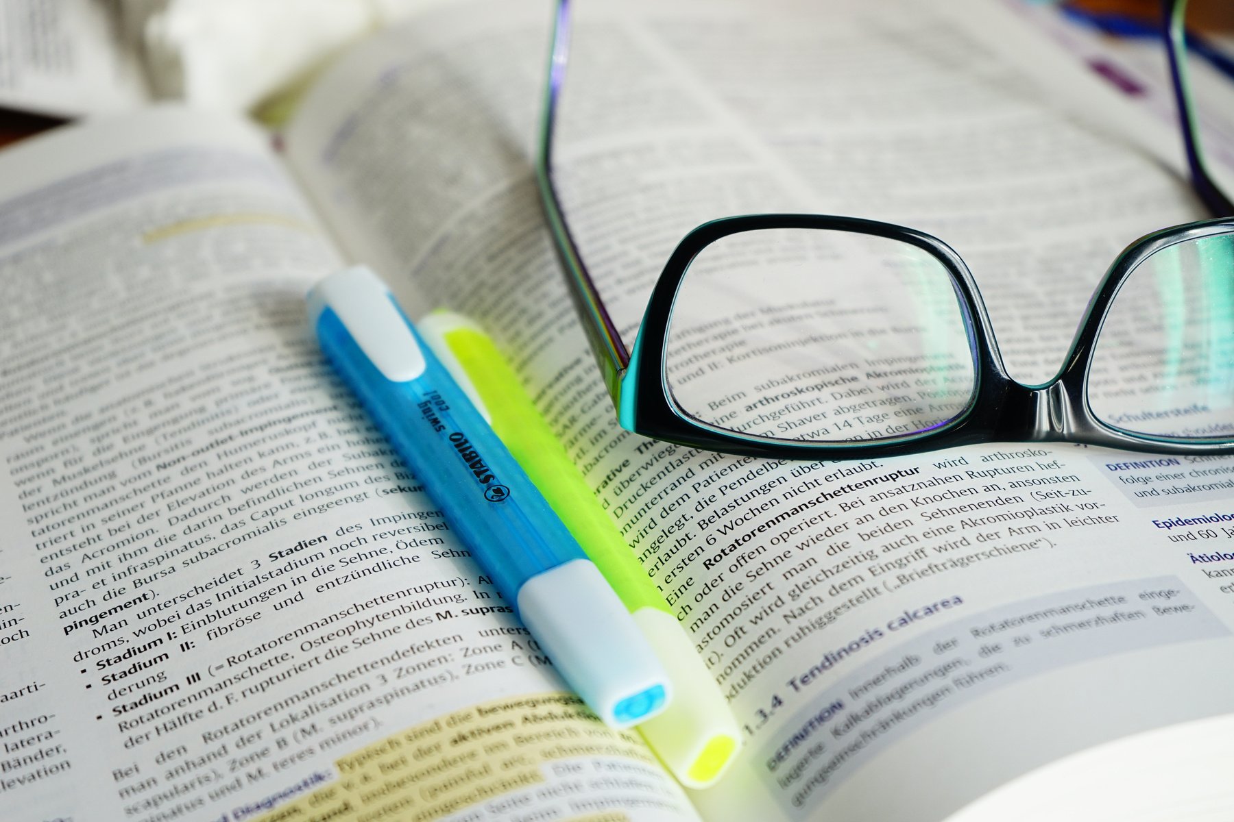 Reading Glasses and Pen on a Open Book